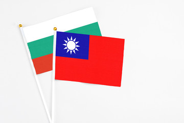 Taiwan and Bulgaria stick flags on white background. High quality fabric, miniature national flag. Peaceful global concept.White floor for copy space.