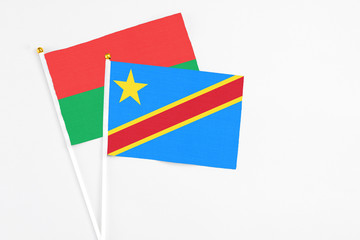 Congo and Burkina Faso stick flags on white background. High quality fabric, miniature national flag. Peaceful global concept.White floor for copy space.