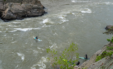 Three Men on Kayak paddling on the river