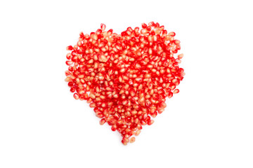 Obraz na płótnie Canvas Pomegranate seeds isolated on white. Heart symbol.