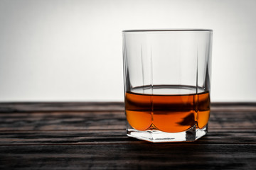 glass of whiskey on a wooden table in a bar