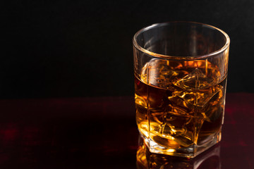 glass of whiskey on a black table