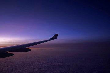 Plane, aeroplane wing, clouds,  gradient sky from aerial view