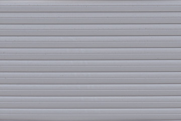 Background of parallel metal stripes, close-up