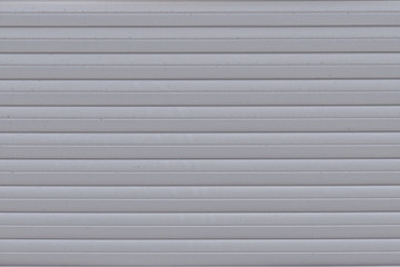 Background of parallel metal stripes, close-up