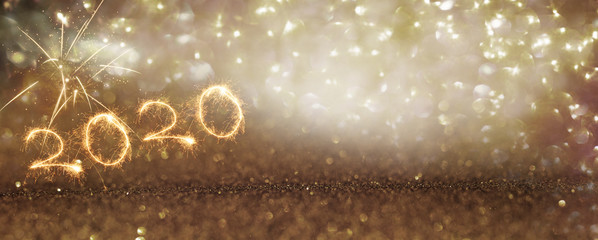 New year 2020 firework on gold glittering background