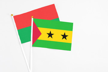 Sao Tome And Principe and Burkina Faso stick flags on white background. High quality fabric, miniature national flag. Peaceful global concept.White floor for copy space.