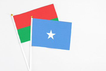 Somalia and Burkina Faso stick flags on white background. High quality fabric, miniature national flag. Peaceful global concept.White floor for copy space.