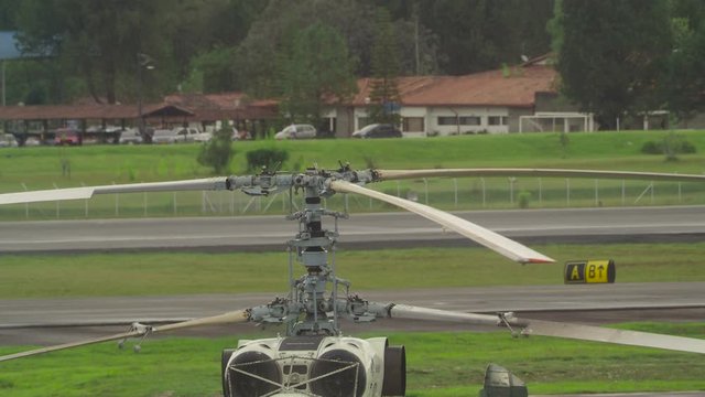 Slowly Turning Helicopter Rotors on Airfield During Prepairing for Flight