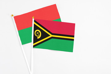 Vanuatu and Burkina Faso stick flags on white background. High quality fabric, miniature national flag. Peaceful global concept.White floor for copy space.