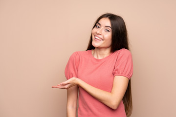 Young woman over isolated background extending hands to the side for inviting to come