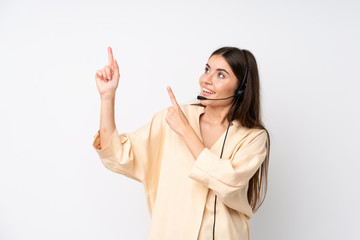 Young telemarketer woman over isolated white background pointing with the index finger a great idea
