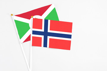 Bouvet Islands and Burundi stick flags on white background. High quality fabric, miniature national flag. Peaceful global concept.White floor for copy space.