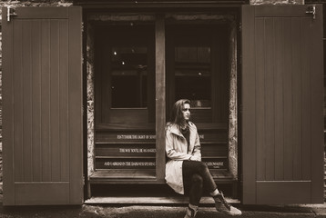 Young woman pensive in store window