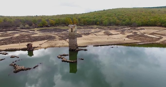 Church tower in an almost dry marsh, La cuerda del pozo, Soria, Vinuesa, Spain. Filmed by a drone