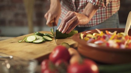 Woman slicing fresh healthy vegetables in the kitchen - Powered by Adobe