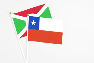 Chile and Burundi stick flags on white background. High quality fabric, miniature national flag. Peaceful global concept.White floor for copy space.