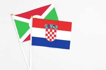 Croatia and Burundi stick flags on white background. High quality fabric, miniature national flag....