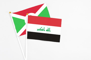 Iraq and Burundi stick flags on white background. High quality fabric, miniature national flag. Peaceful global concept.White floor for copy space.