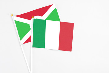 Italy and Burundi stick flags on white background. High quality fabric, miniature national flag. Peaceful global concept.White floor for copy space.