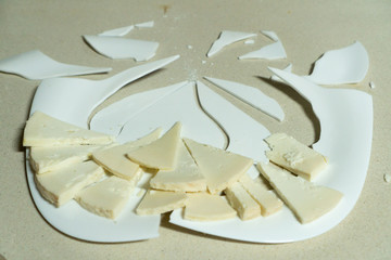 cheese portion on broken plate