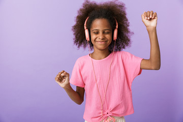 Happy young african girl kid with headphones.