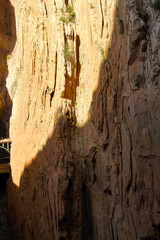 Brown red mountains shale steep cliffs near the trail, mountain trail along steep cliffs in Spain, Ardales the caminito caminito del rey. Tall red rocks mountain side in el Chorro
