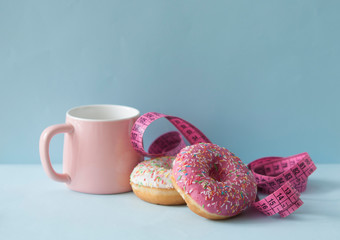 Delicious doughnuts with sprinkles on color background