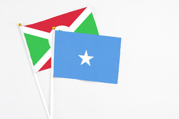 Somalia and Burundi stick flags on white background. High quality fabric, miniature national flag. Peaceful global concept.White floor for copy space.