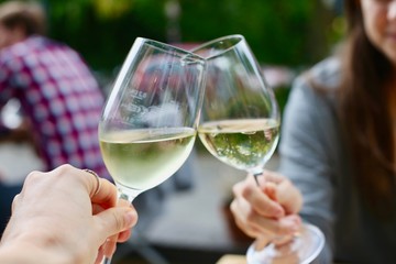 Cheers, wine glasses together in celebration
