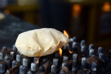 Indian Roti or Phulka roti on grill