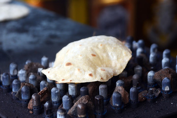 Indian Roti or Phulka roti on grill