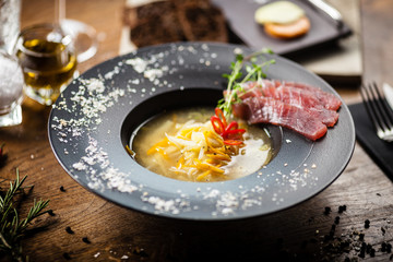Clear Fish soup served in a bowl in restaurant