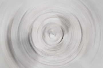 Blurred radial motion gradient gray background. Circular brushed texture