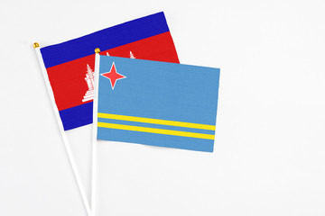 Aruba and Cambodia stick flags on white background. High quality fabric, miniature national flag....