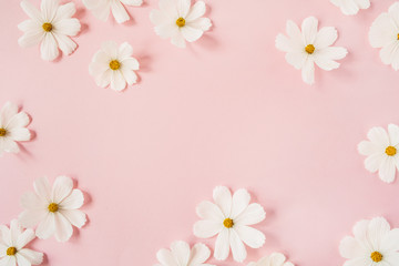 Minimal styled concept. White daisy chamomile flowers on pale pink background. Creative lifestyle,...