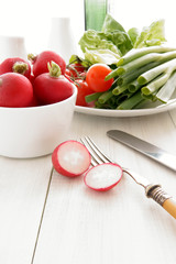 Summer salad with radishes, tomatoes and spring onions