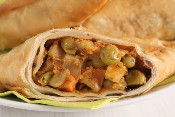 Samosas a spicy blend of vegetables or meat wrapped in a deep fried triangular pastry parcel a popular snack in the Middle East and South Asia
