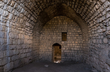 Fototapeta na wymiar The side hall in ruins of crusader Fortress Chateau Neuf - Metsudat Hunin is located at the entrance to the Israeli Margaliot village in the Upper Galilee in northern Israel