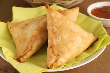 Samosas a spicy blend of vegetables or meat wrapped in a deep fried triangular pastry parcel a popular snack in the Middle East and South Asia