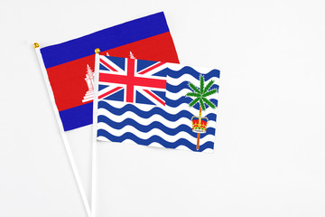 British Indian Ocean Territory and Cambodia stick flags on white background. High quality fabric, miniature national flag. Peaceful global concept.White floor for copy space.