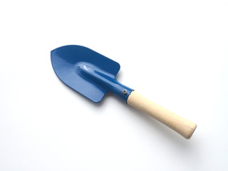 The blue metal hand trowel with wooden handle is on the white background.