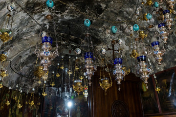 Many lamps hang under the ceiling in the Tomb of the Virgin on foot of the mountain Mount Eleon - Mount of Olives in East Jerusalem in Israel