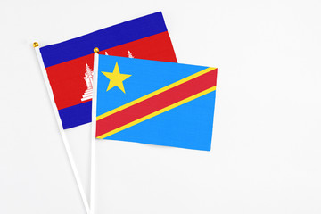 Congo and Cambodia stick flags on white background. High quality fabric, miniature national flag. Peaceful global concept.White floor for copy space.