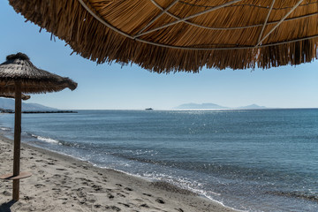 Umbrellas on Kardamena city beach in Kos island, Greece.