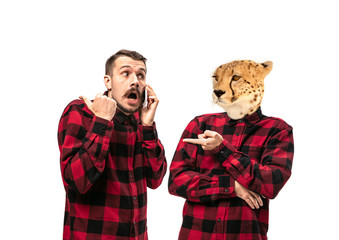 Portrait of man arguing with himself as a leopard on white studio background. Concept of human...