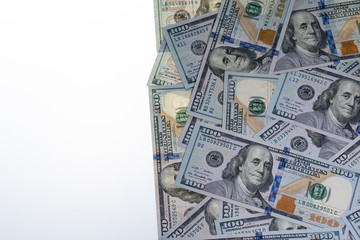 One Hundred Dollar Bills with White Background on the Left