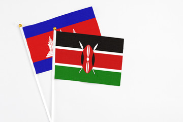 Kenya and Cambodia stick flags on white background. High quality fabric, miniature national flag....