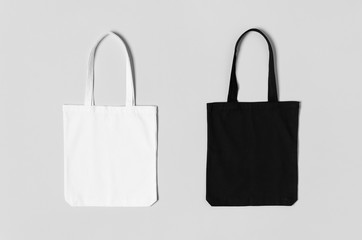 Fototapeta White and black tote bags mockup on a grey background. obraz