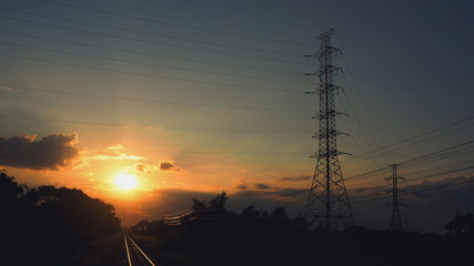 Fototapeta premium Pictures of electrical transportation through high voltage poles during sunrise time. Electric power transportation concept